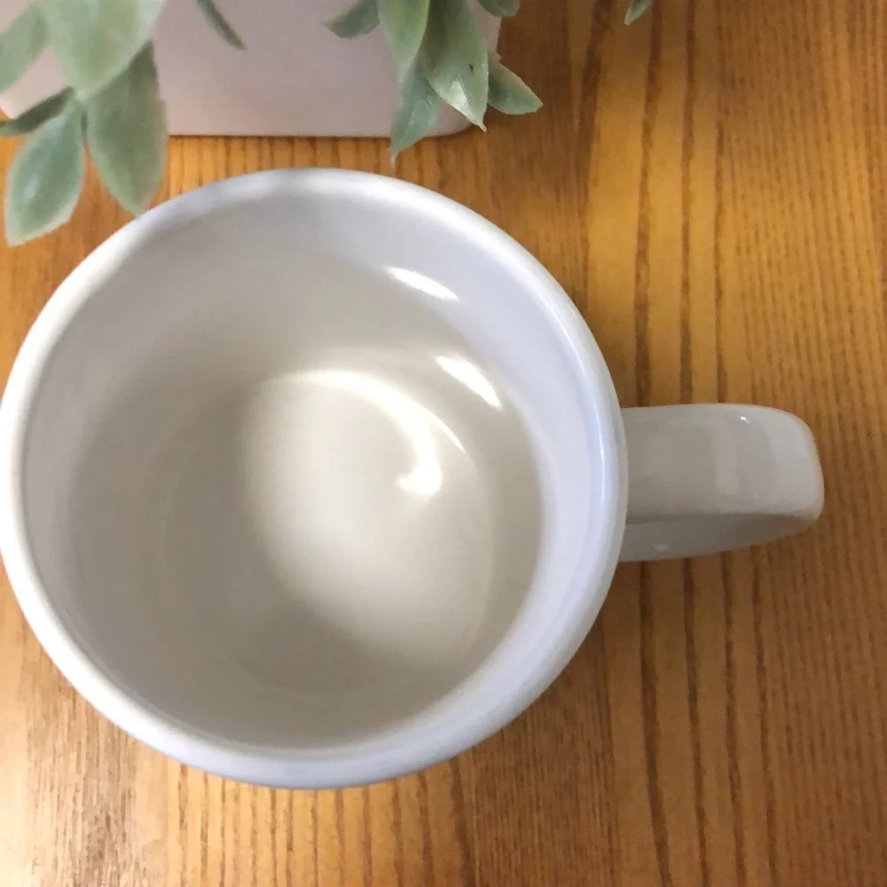 Coffe cup with cardinals in winter scene